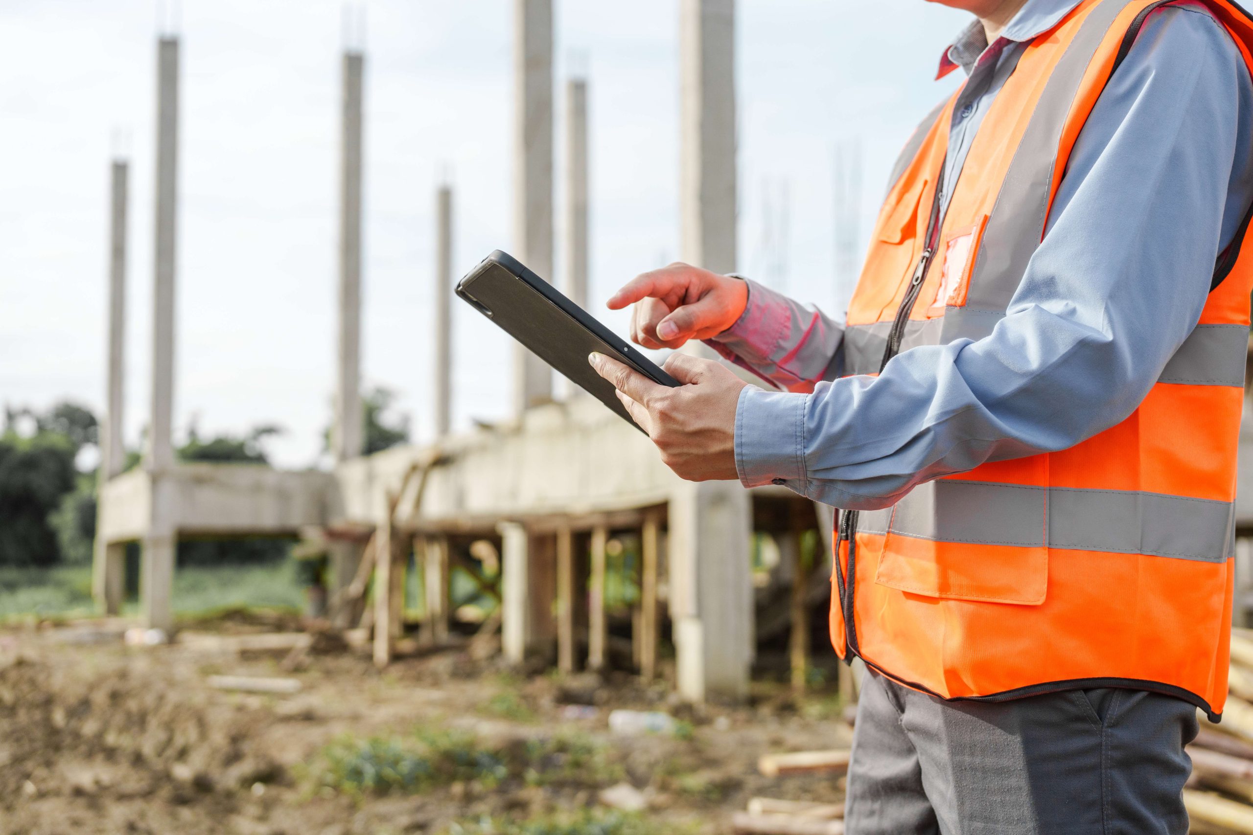 Site supervisor reviewing a LOLER-compliant inspection checklist on a tablet