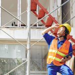 Competent person carrying out a weekly scaffold inspection on a UK construction site