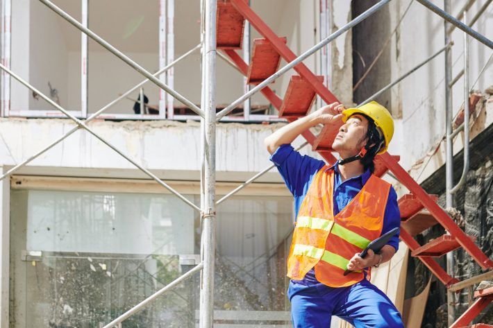 Competent person carrying out a weekly scaffold inspection on a UK construction site