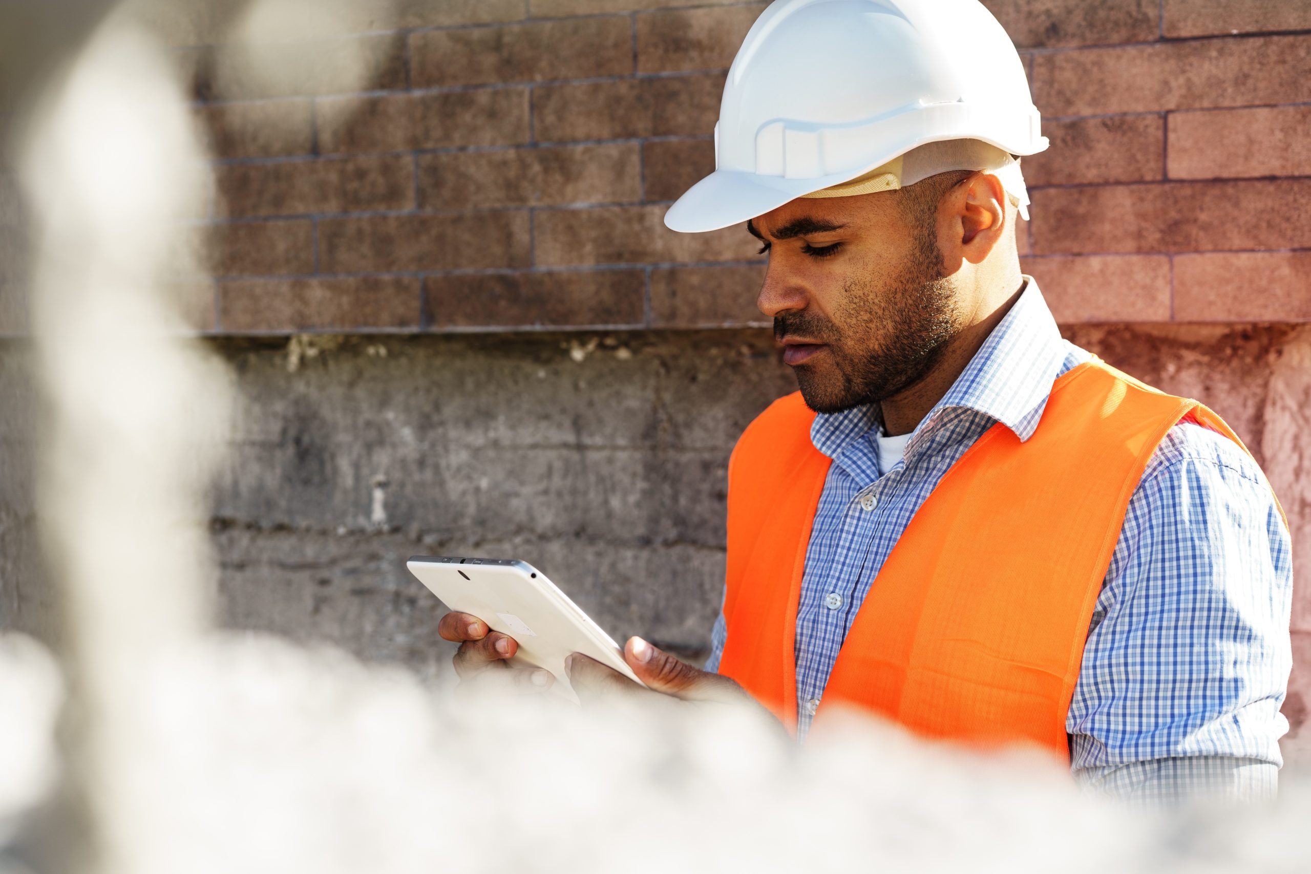 Worker completing a digital scaffold inspection checklist on site with workMule