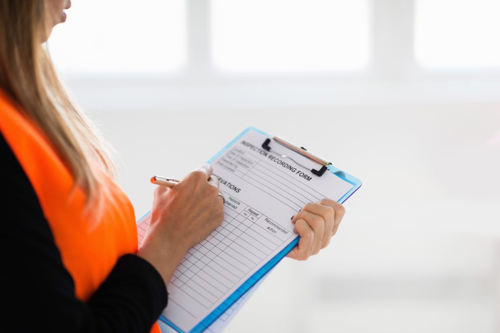 Completing a scaffold inspection report recording the statutory details required under UK law