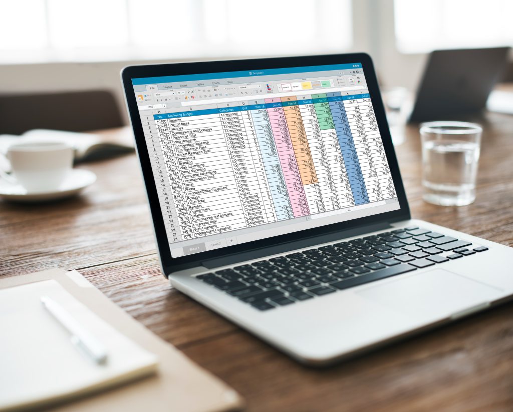 Spreadsheet open on a laptop on an office desk