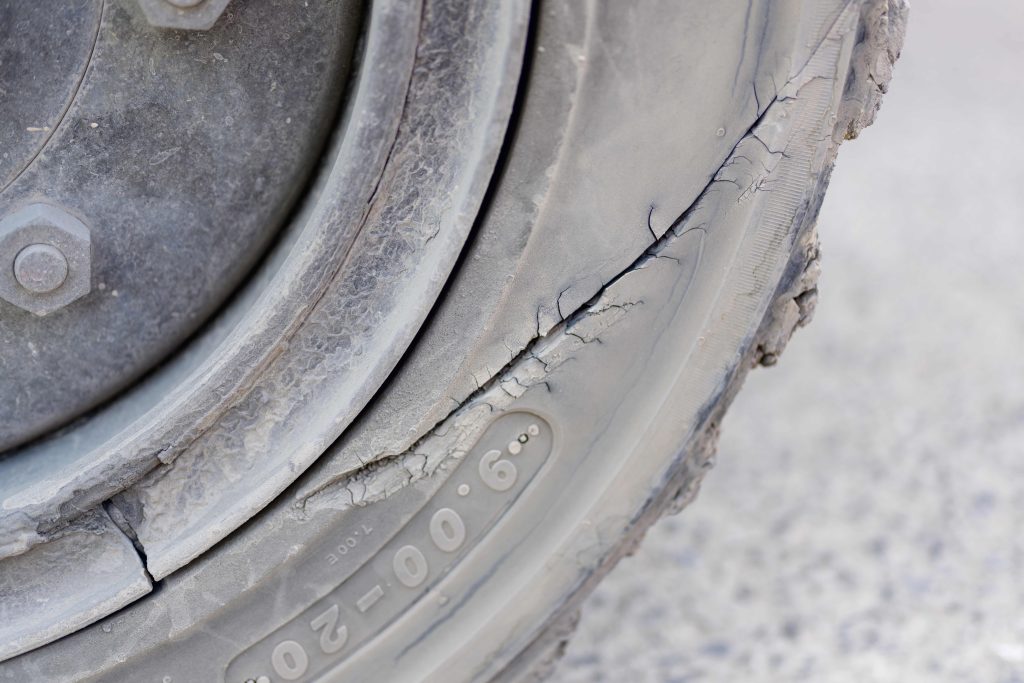 Cracked and perished sidewall on a heavy goods vehicle tyre